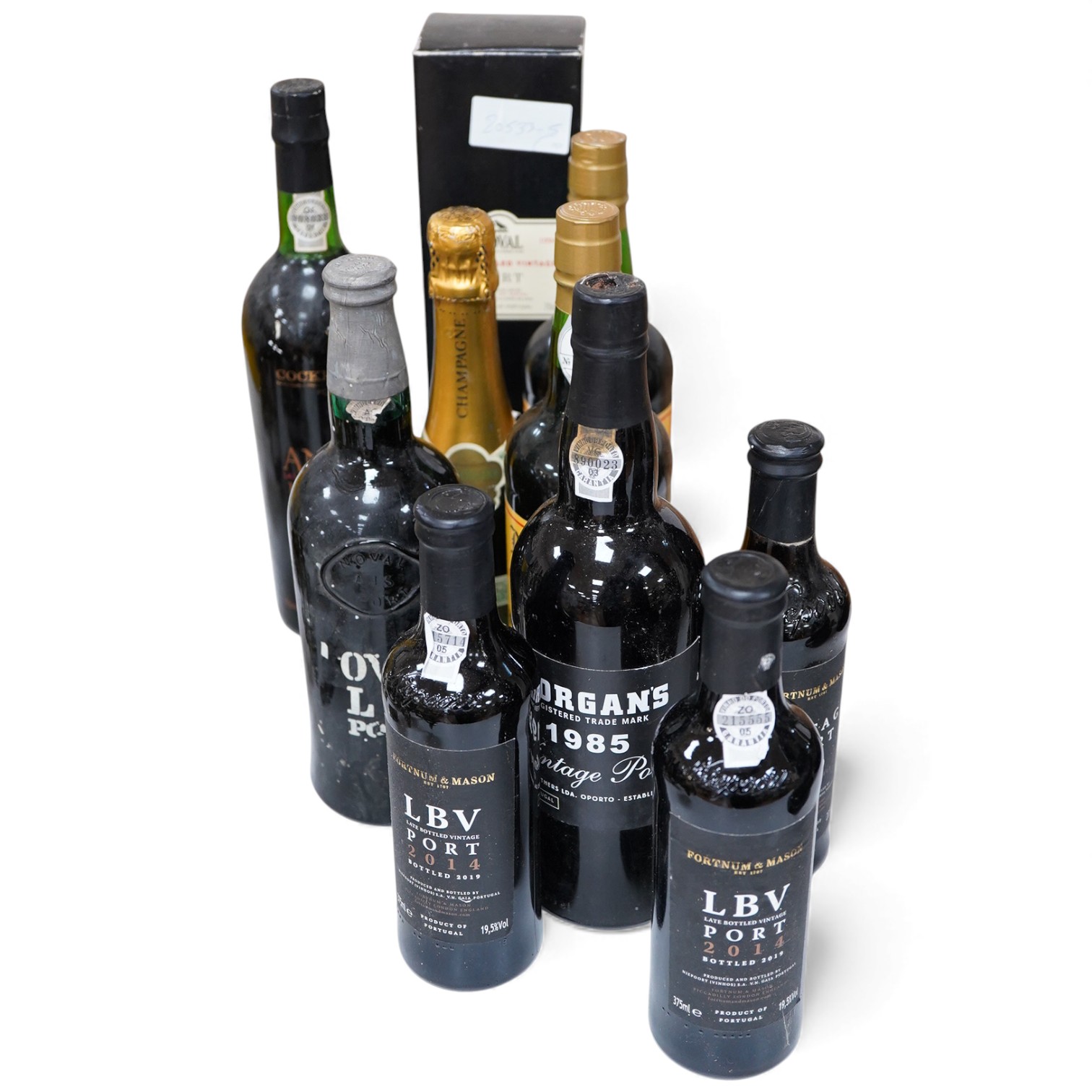 Seven assorted ports including Morgan’s 1985 and three half bottle Fortnum & Mason, together with two Madeira wines and a half bottle of Champagne.